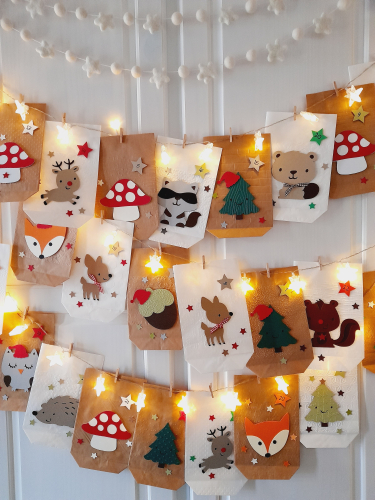 Preview: Handgemachter Adventskalender mit Waldtieren – 24 Papiertüten in Weiß & Braun